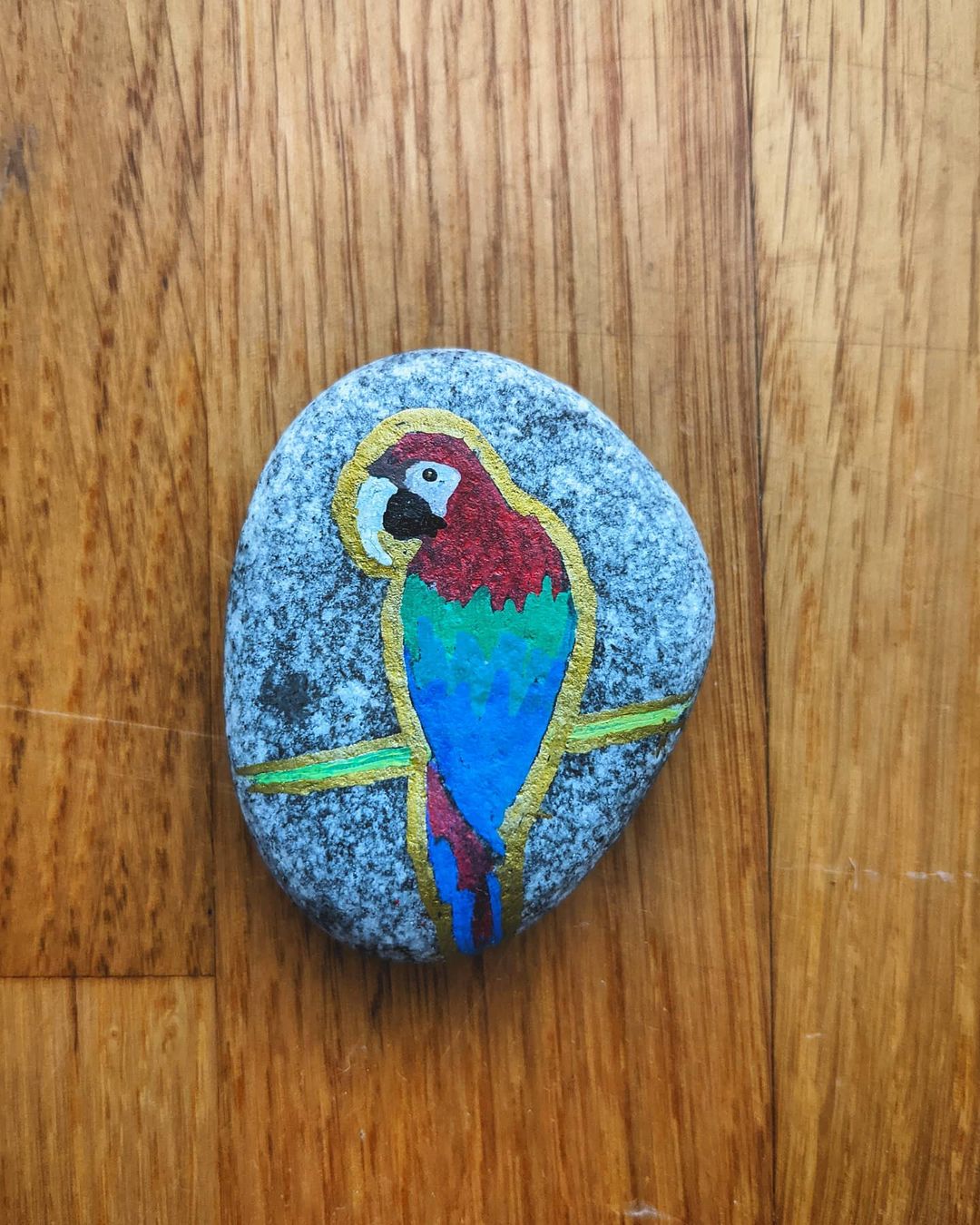 parrot painting on a stone
